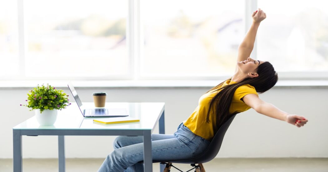 business-woman-relaxing-with-hands-her-head-sitting-office-chair (1)-min